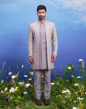 Open grey jacquard Indo-western outfit, men's ethnic fusion wear, featuring a jacquard top, trousers, and long sleeveless jacket.