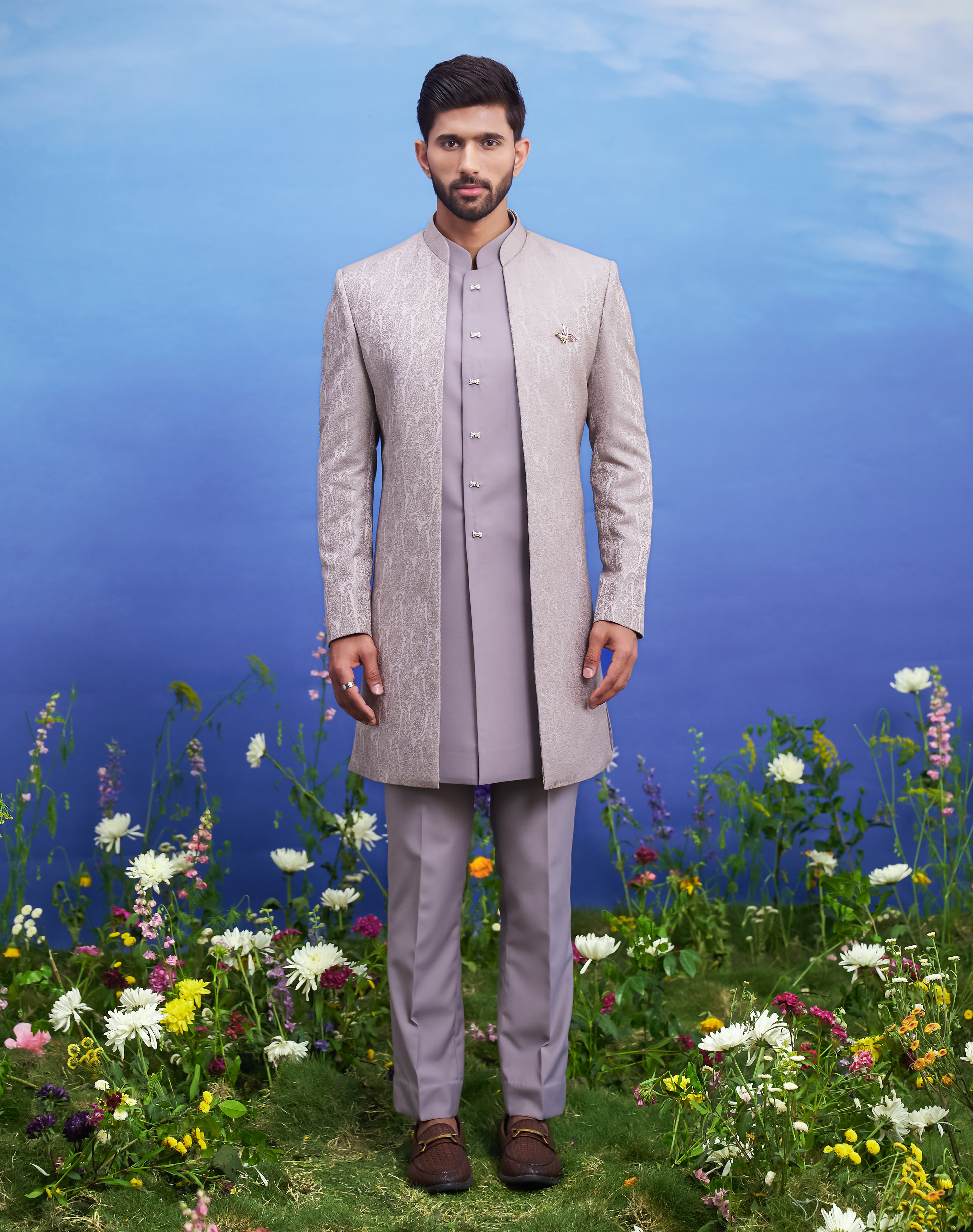 Open grey jacquard Indo-western outfit, men's ethnic fusion wear, featuring a jacquard top, trousers, and long sleeveless jacket.