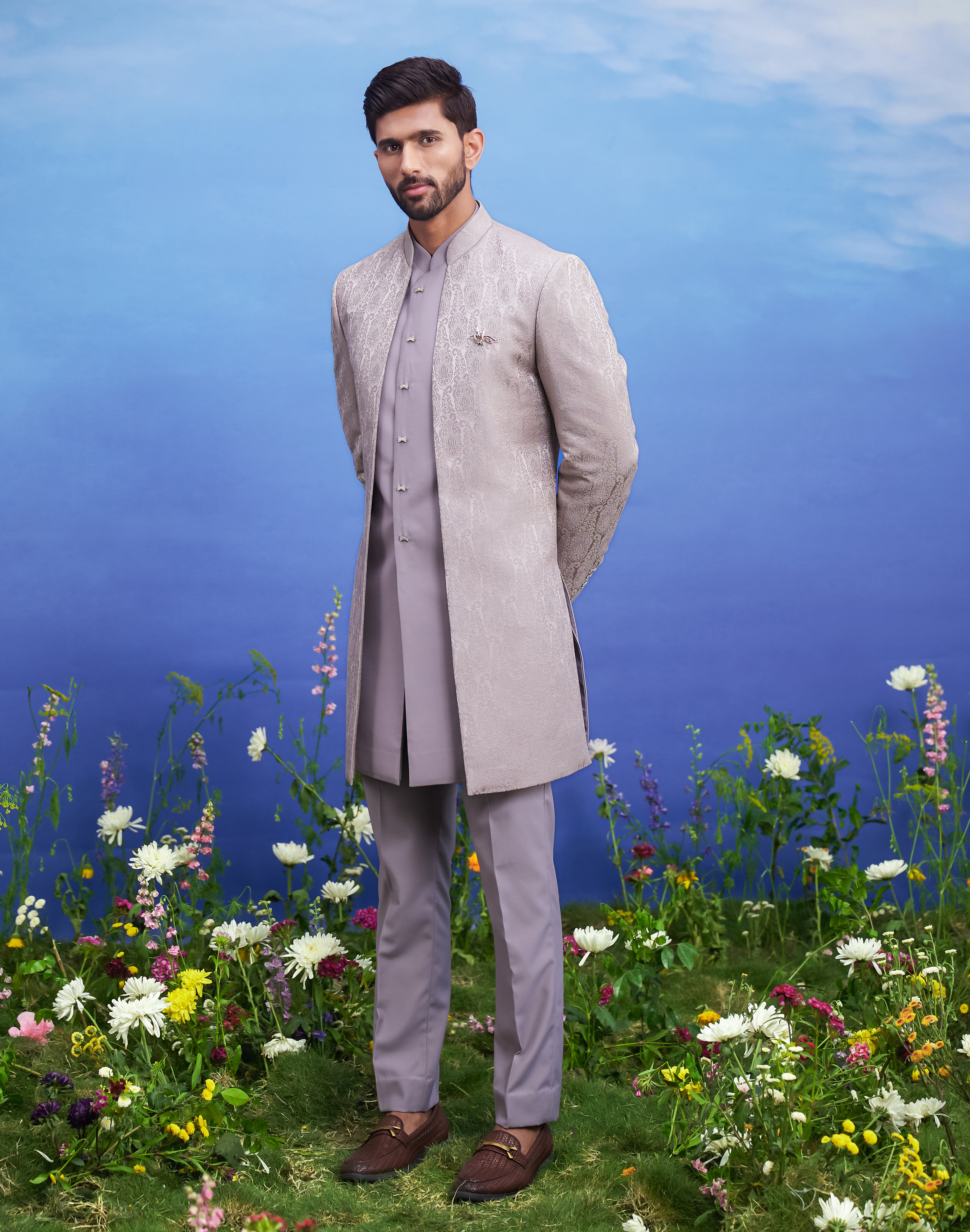 Men's grey Indo-western suit with an open front design, displayed on a product page with size options.