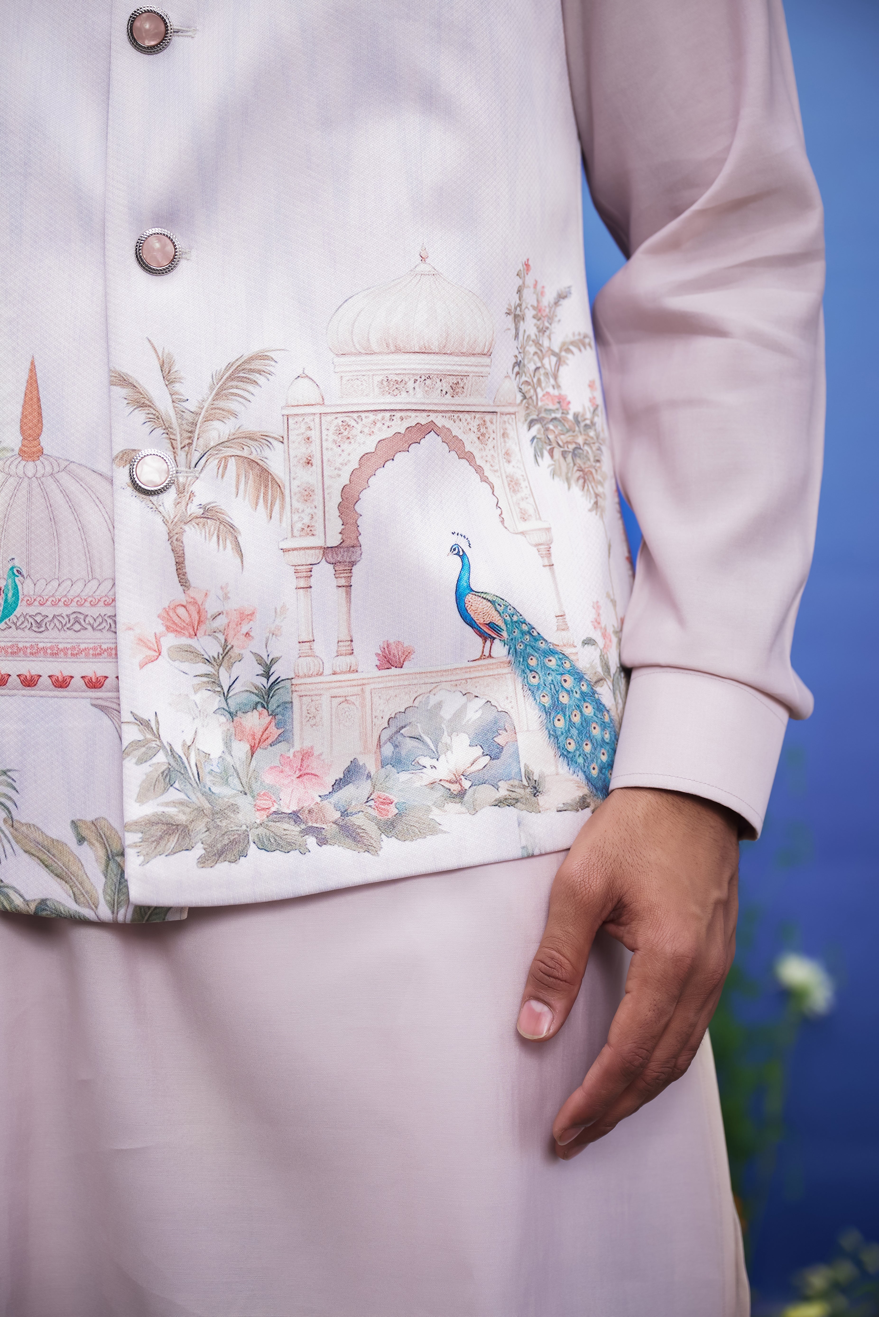 Men's pink Nehru jacket with a peacock motif print, displayed on a product page with size options.