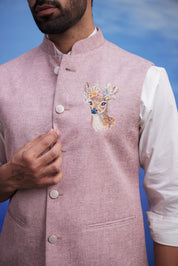 Close-up of the pink Nehru jacket, highlighting the embroidered motif and linen fabric.