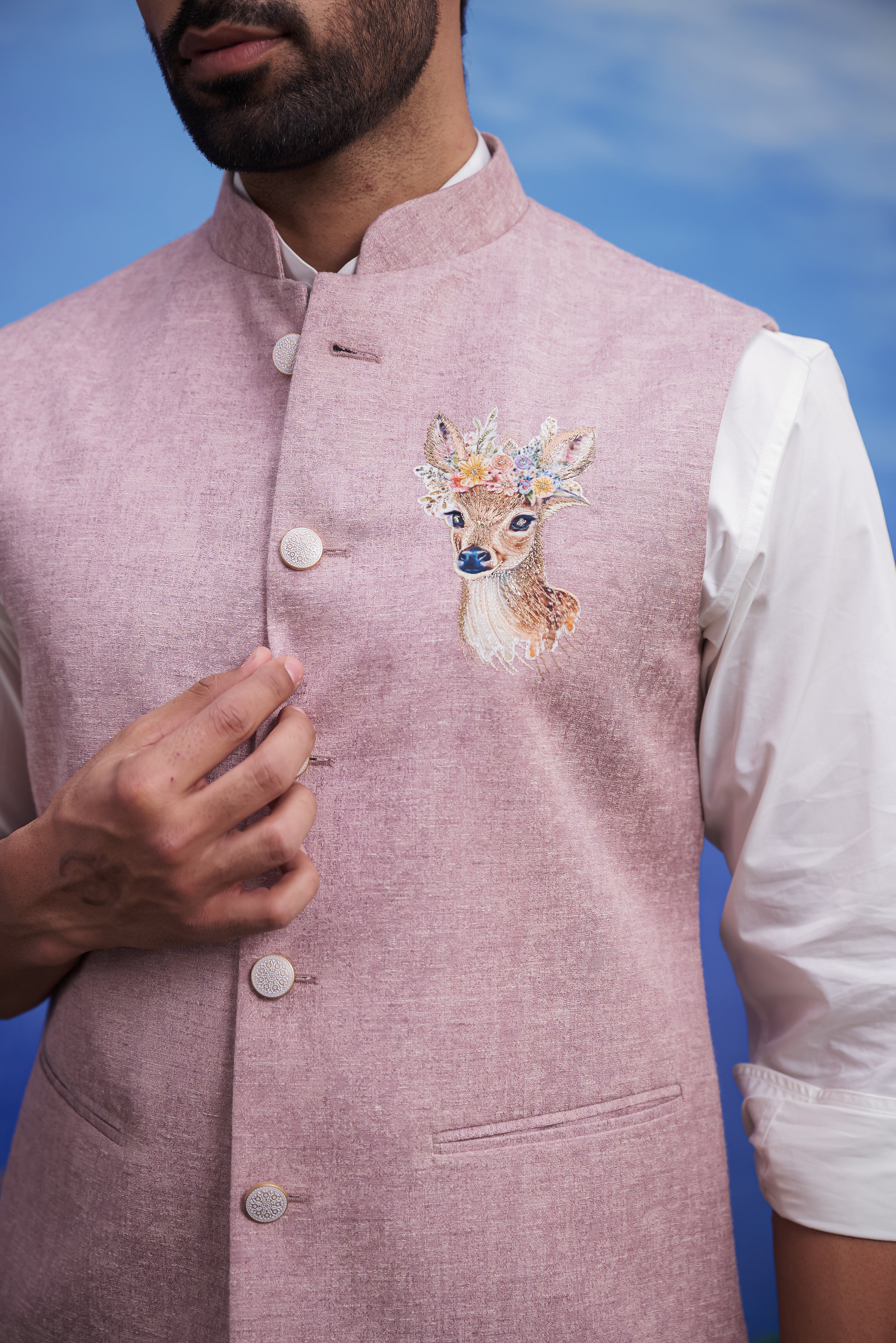 Close-up of the pink Nehru jacket, highlighting the embroidered motif and linen fabric.