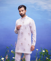 Men's pink kurta set made of linen blend, displayed on a product page with size options.