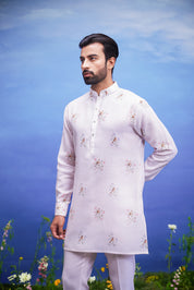 Pink linen kurta set, a comfortable and stylish ethnic wear option for men, presented on a product page.