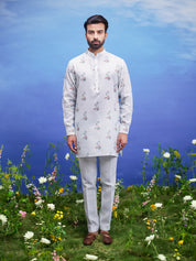 A refreshing mint green linen kurta set, suitable for various occasions, with a floral pattern.
