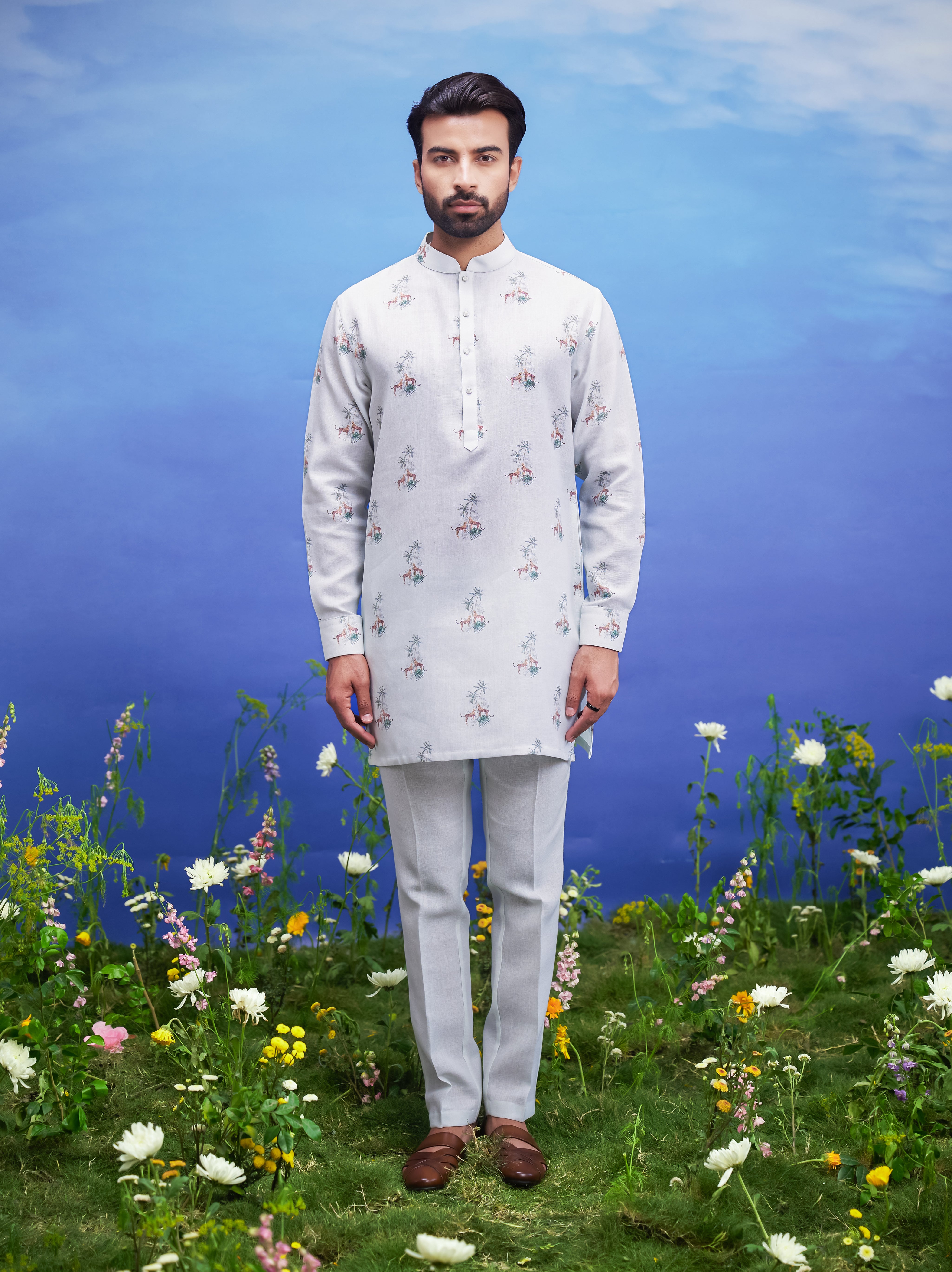 A refreshing mint green linen kurta set, suitable for various occasions, with a floral pattern.