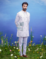 Printed white kurta jacket set for men, blending traditional style with modern floral prints, suitable for festive occasions.