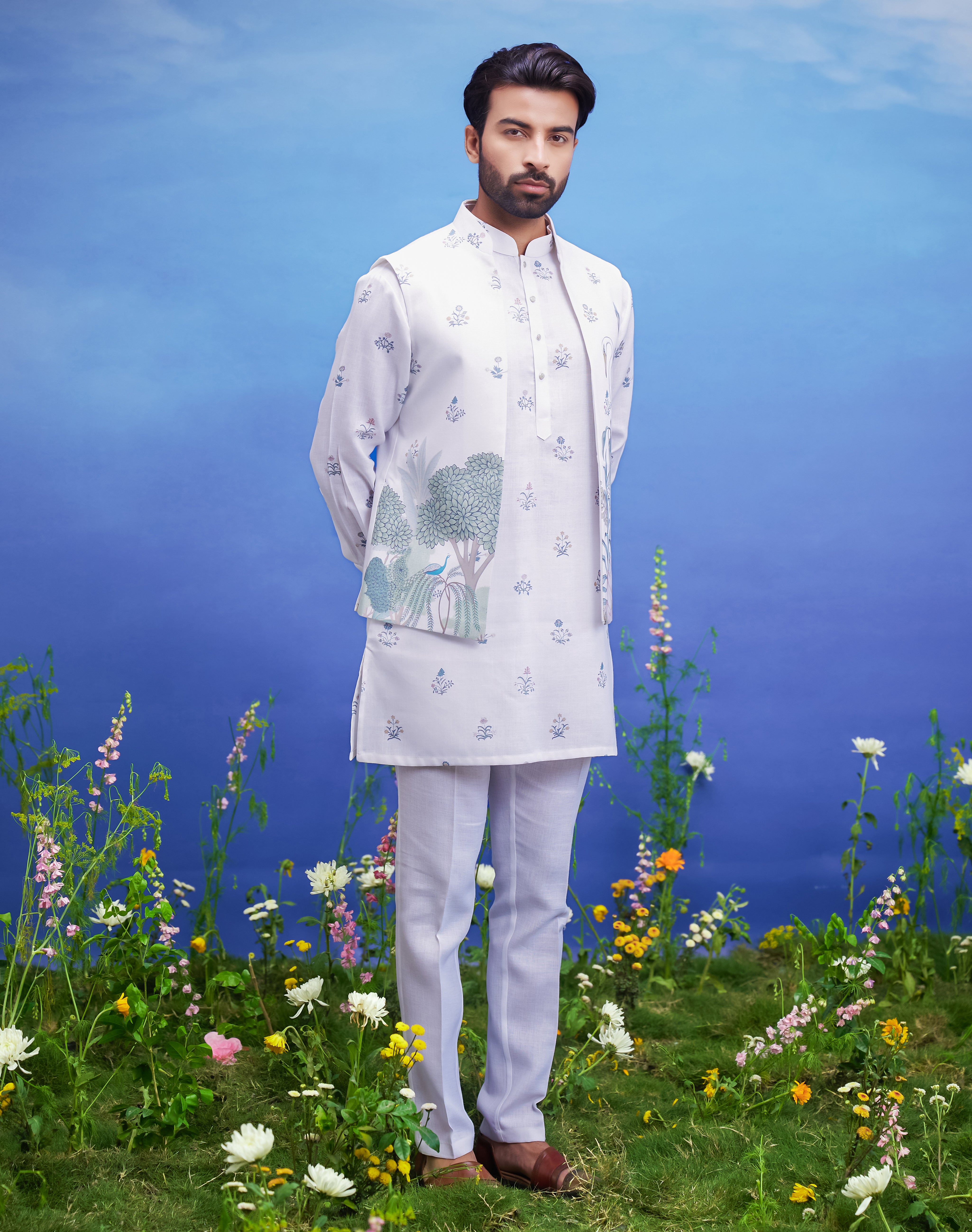 Printed white kurta jacket set for men, blending traditional style with modern floral prints, suitable for festive occasions.