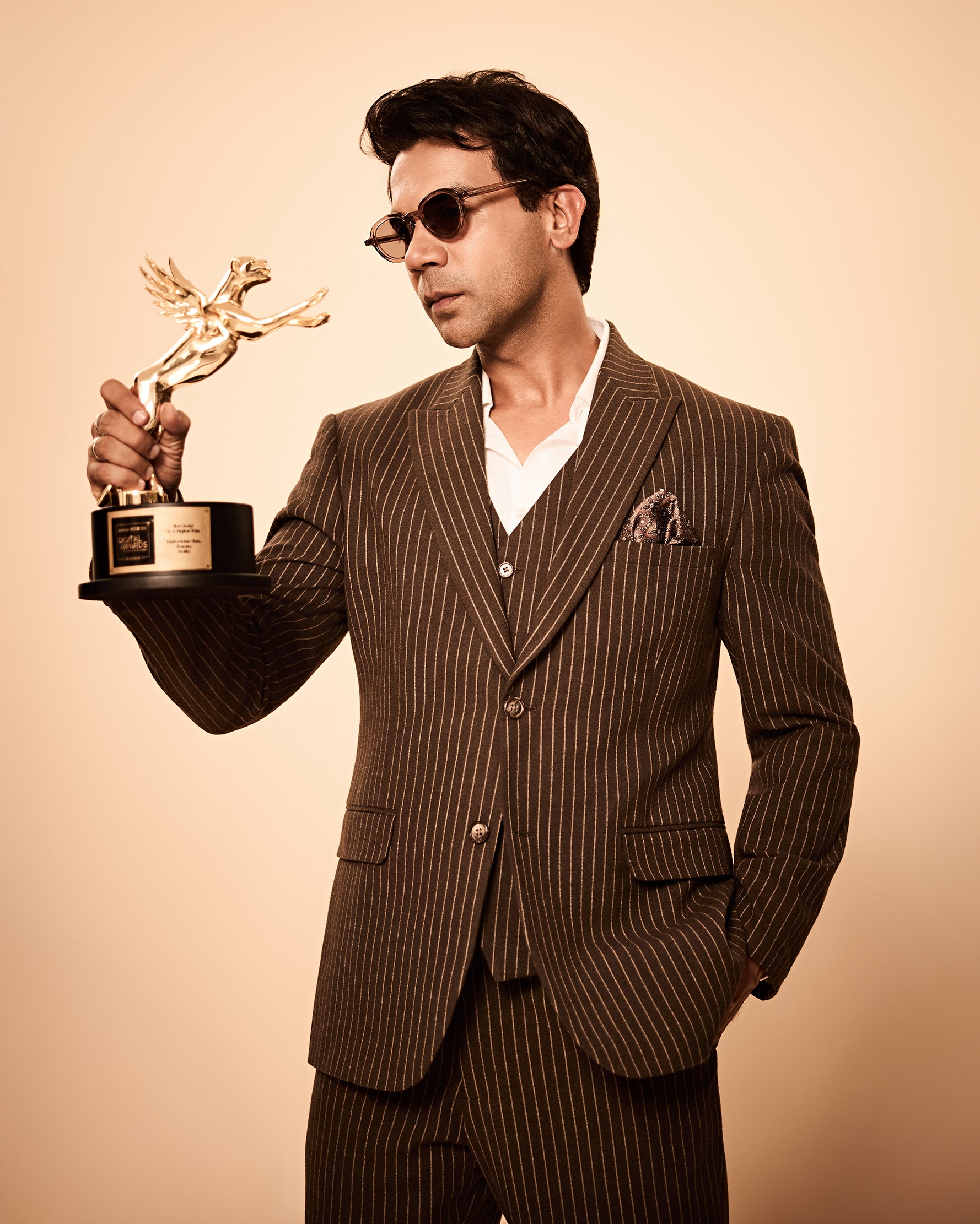 Brown pinstripe 3-piece suit inspired by Rajkummar Rao, featuring a tailored suit, same waistcoat, and trousers in premium wool-feel fabric with a sharp modern fit, ideal for weddings, formal events, business wear, and celebrations.