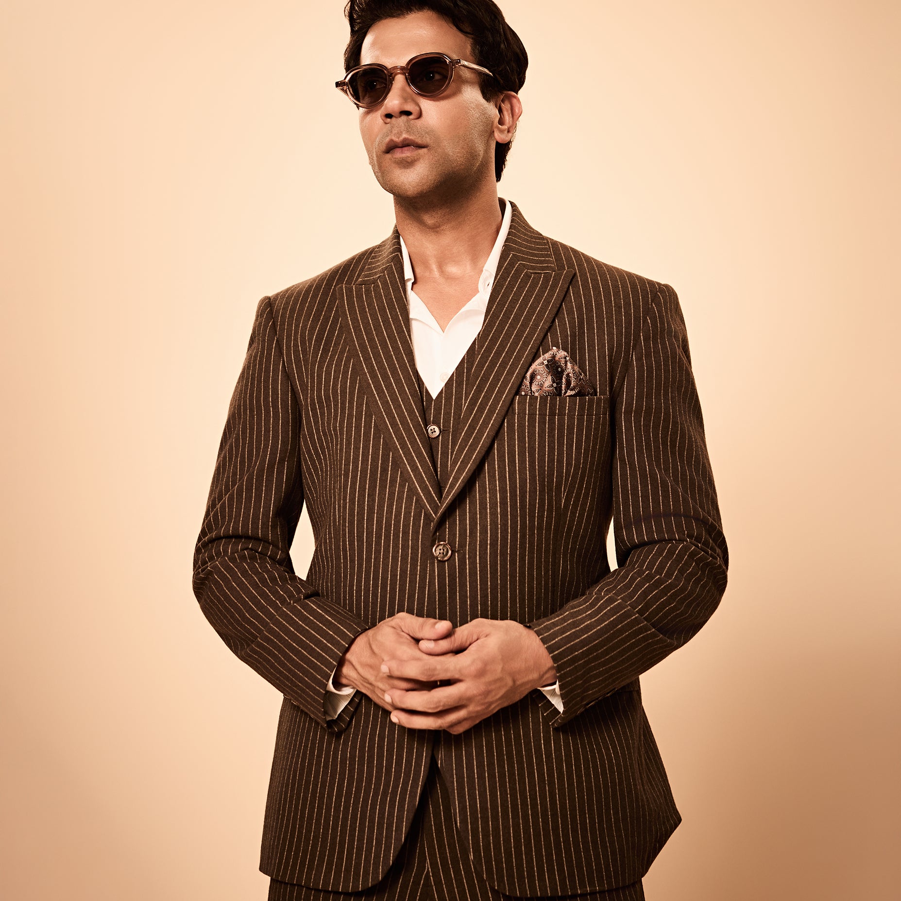 Brown pinstripe 3-piece suit inspired by Rajkummar Rao, featuring a tailored suit, same waistcoat, and trousers in premium wool-feel fabric with a sharp modern fit, ideal for weddings, formal events, business wear, and celebrations.