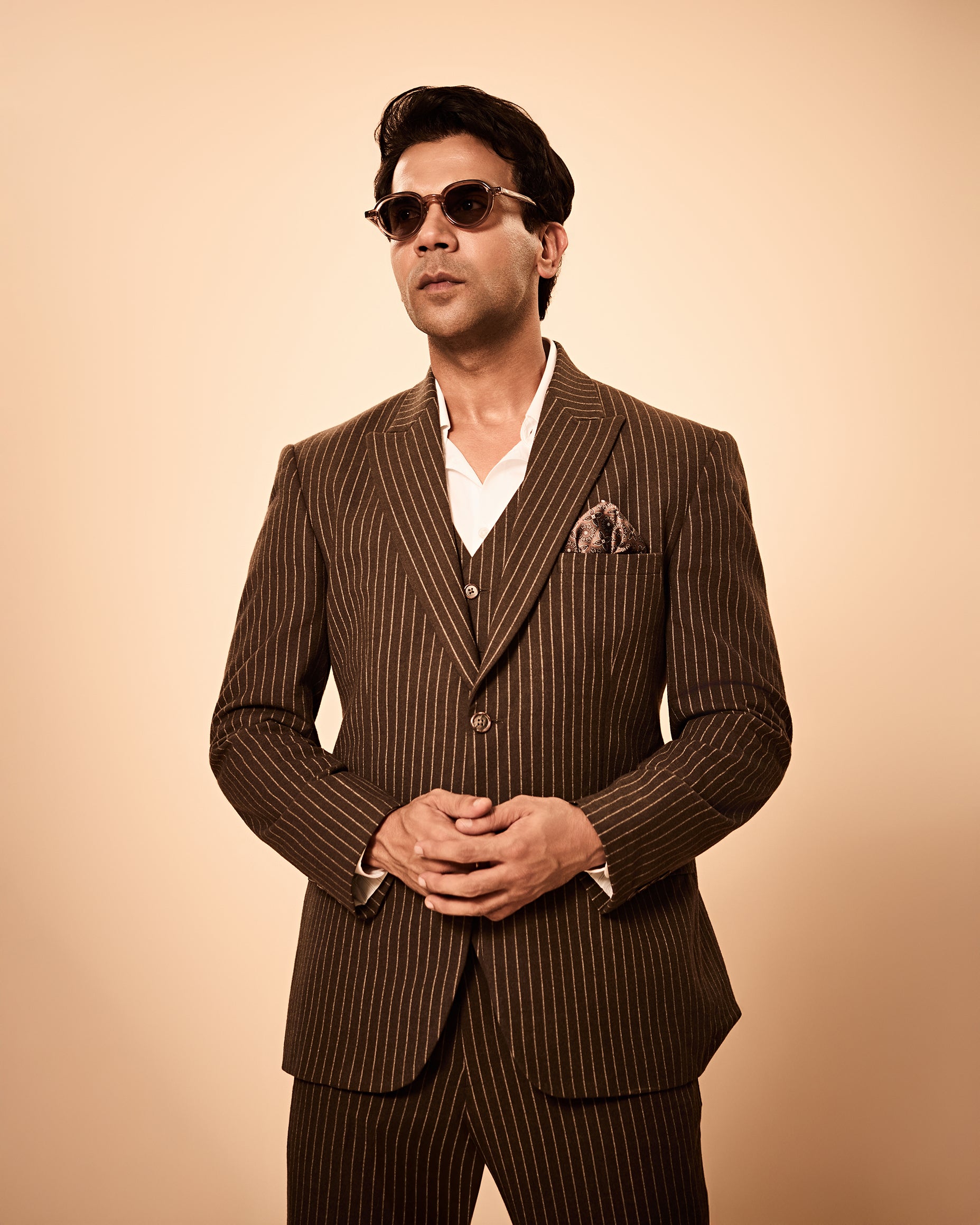 Brown pinstripe 3-piece suit inspired by Rajkummar Rao, featuring a tailored suit, same waistcoat, and trousers in premium wool-feel fabric with a sharp modern fit, ideal for weddings, formal events, business wear, and celebrations.