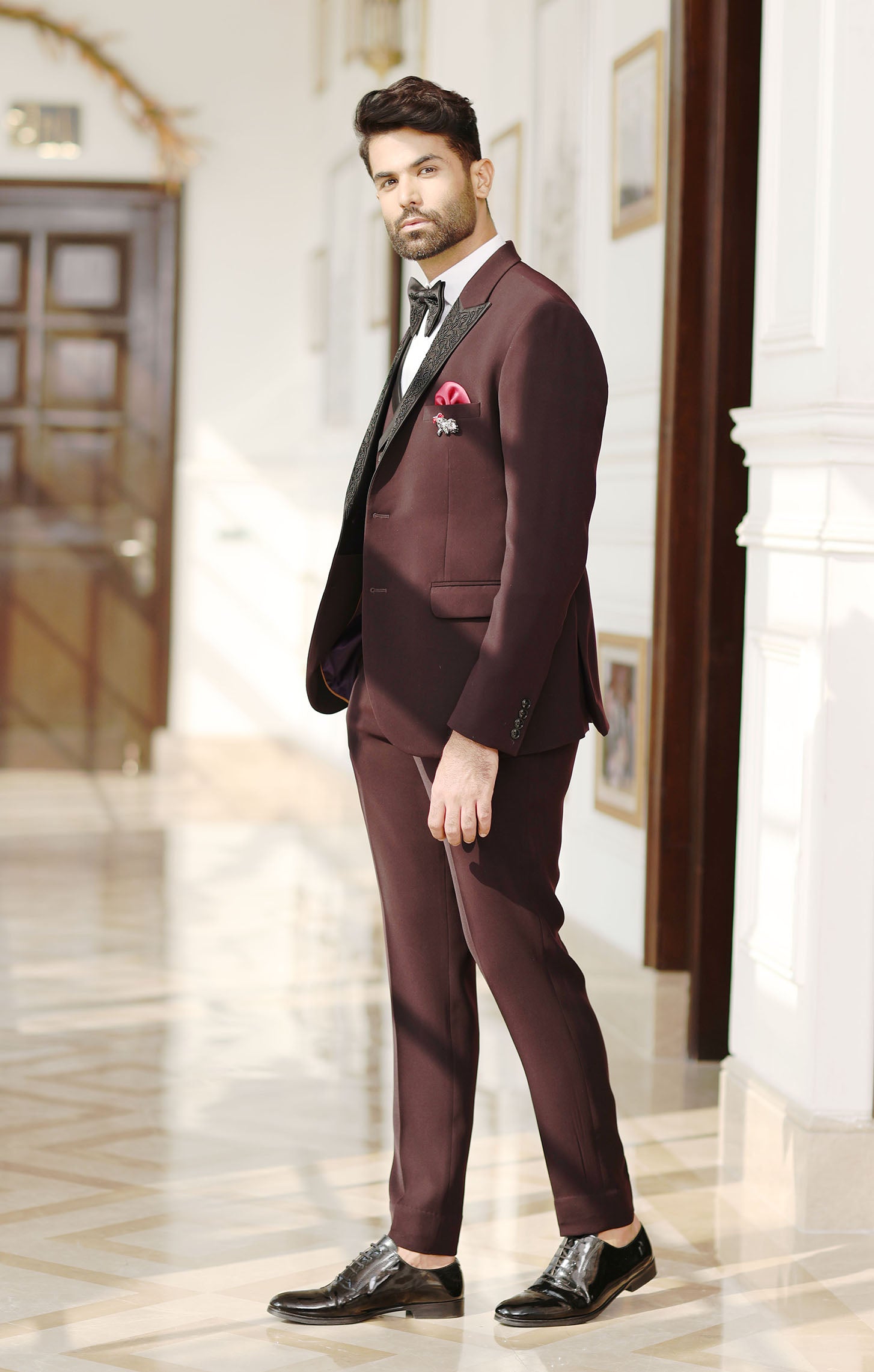 A wine designer suit with embroidery, designer wear.
