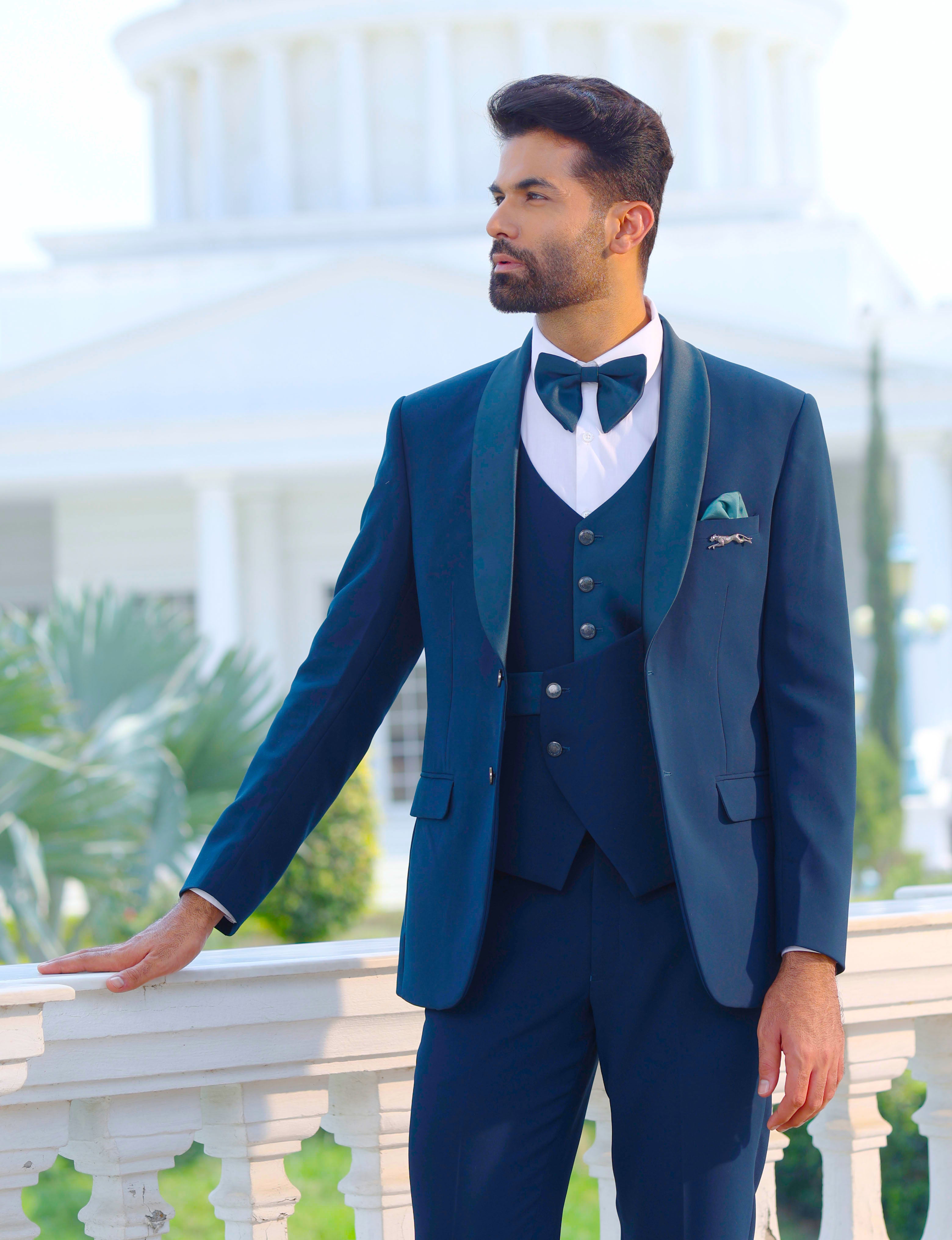 An elegant teal 5-piece suit, modern men's fashion.

