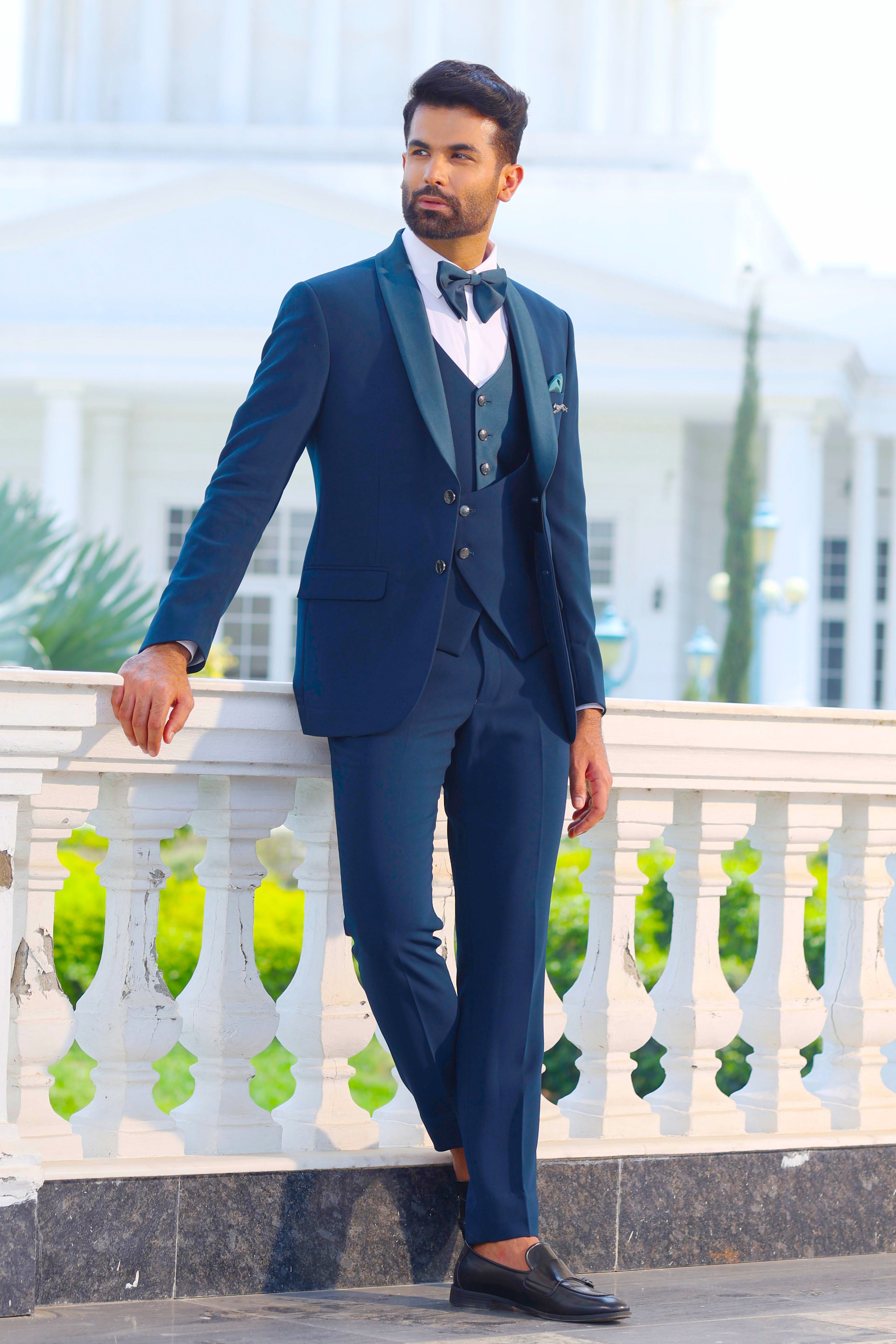 A stylish teal 5-piece suit with designer vest, perfect for weddings and formal occasions.
