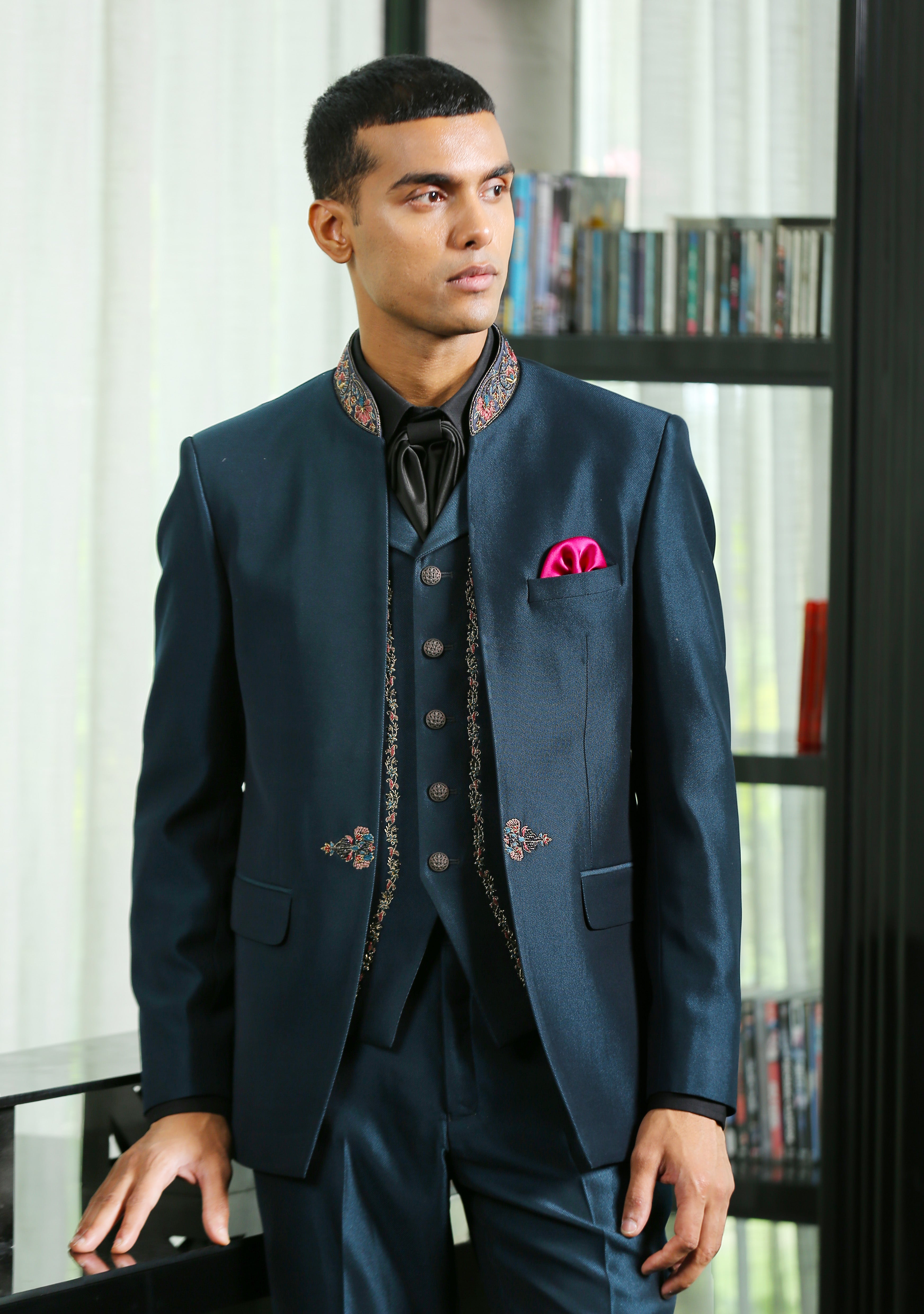 A stylish teal embroidered suit with cravat, perfect for weddings and formal occasions.

