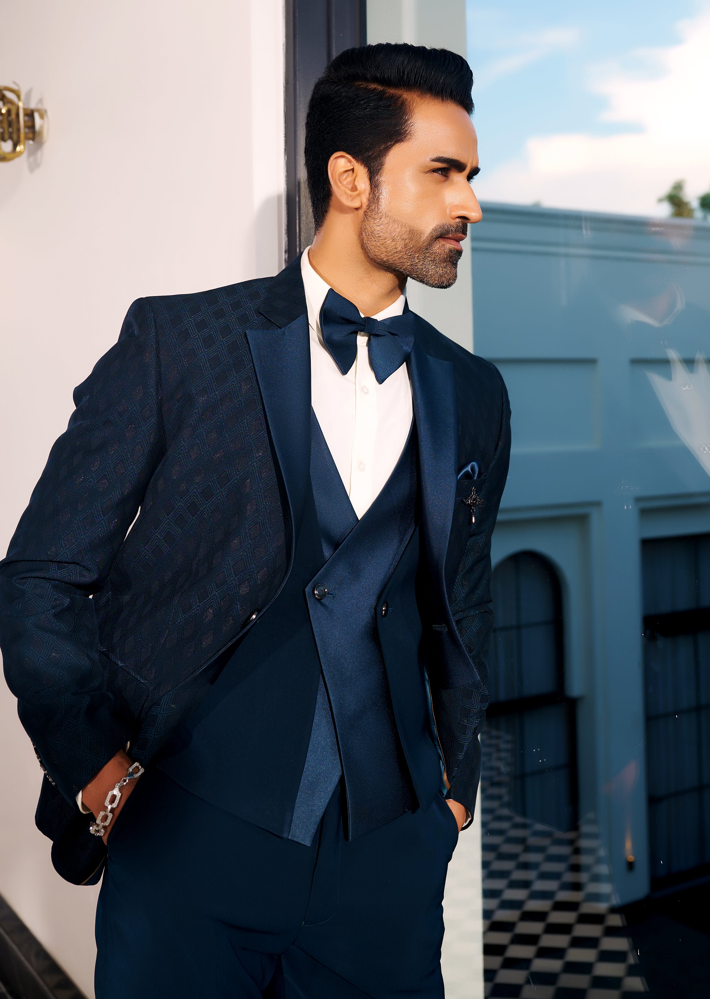 A trendy teal suit with designer vest, urban style.
