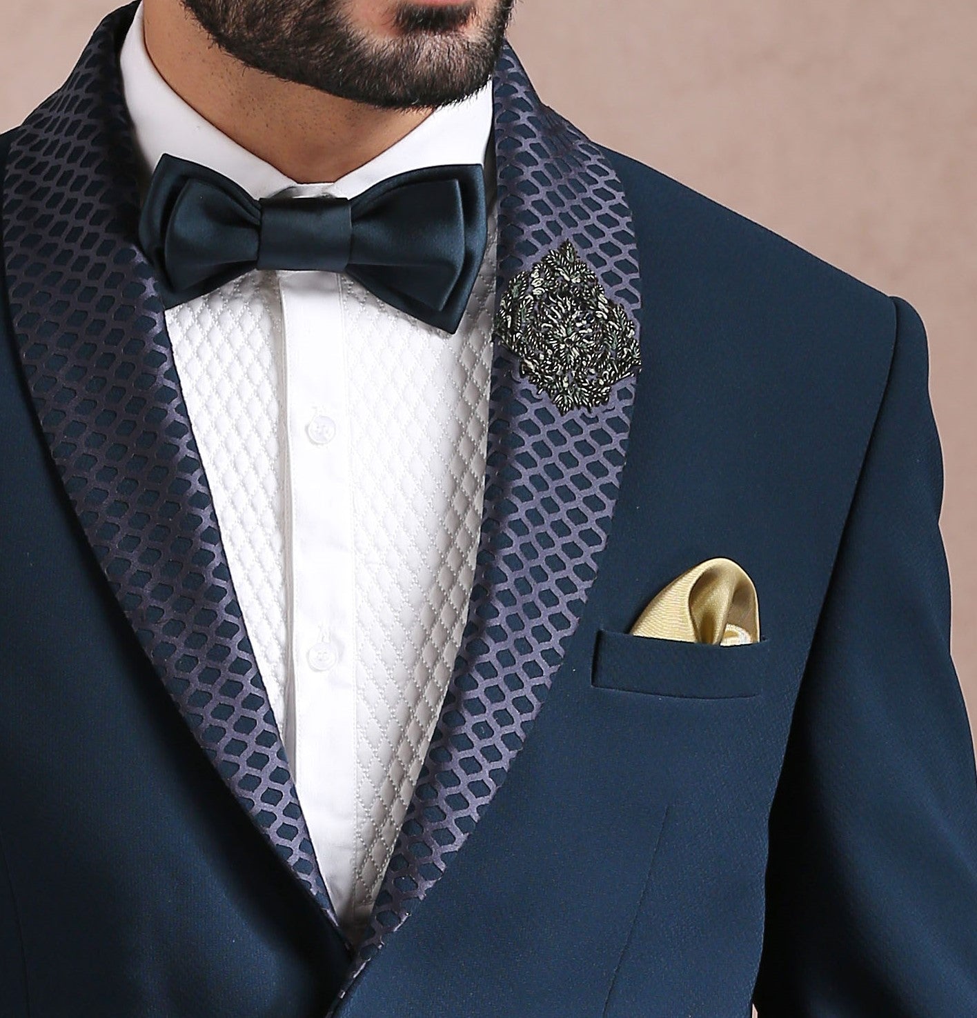 A luxurious teal suit with embroidered motif, perfect for special occasions.
