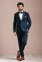 A stylish teal suit with embroidered motif, perfect for weddings and formal occasions.
