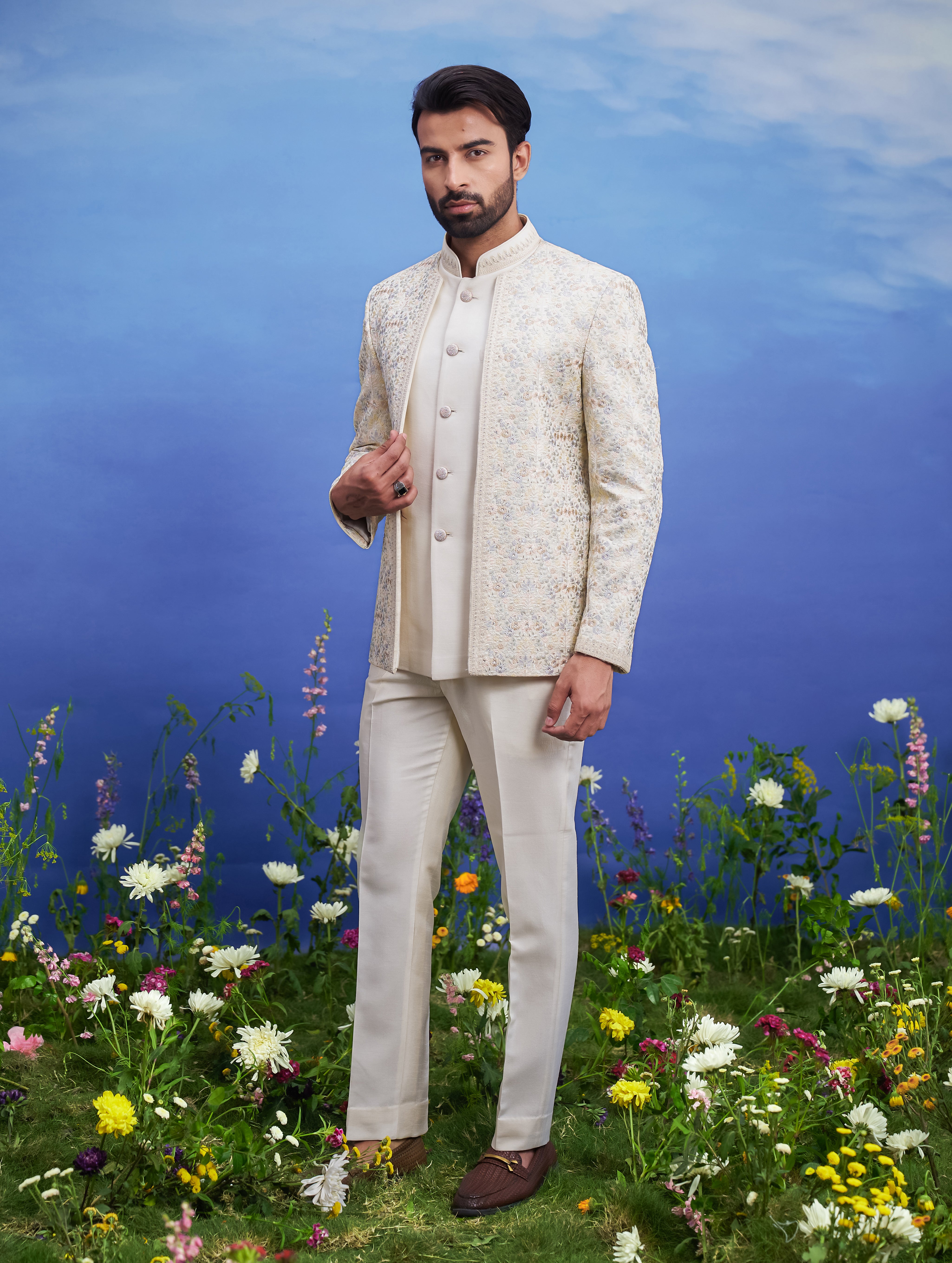 Beige thread embroidered open Bandhgala suit, men's ethnic formal wear, featuring a silk blend Bandhgala, sleeveless rayon jacket, trousers, and brooch.