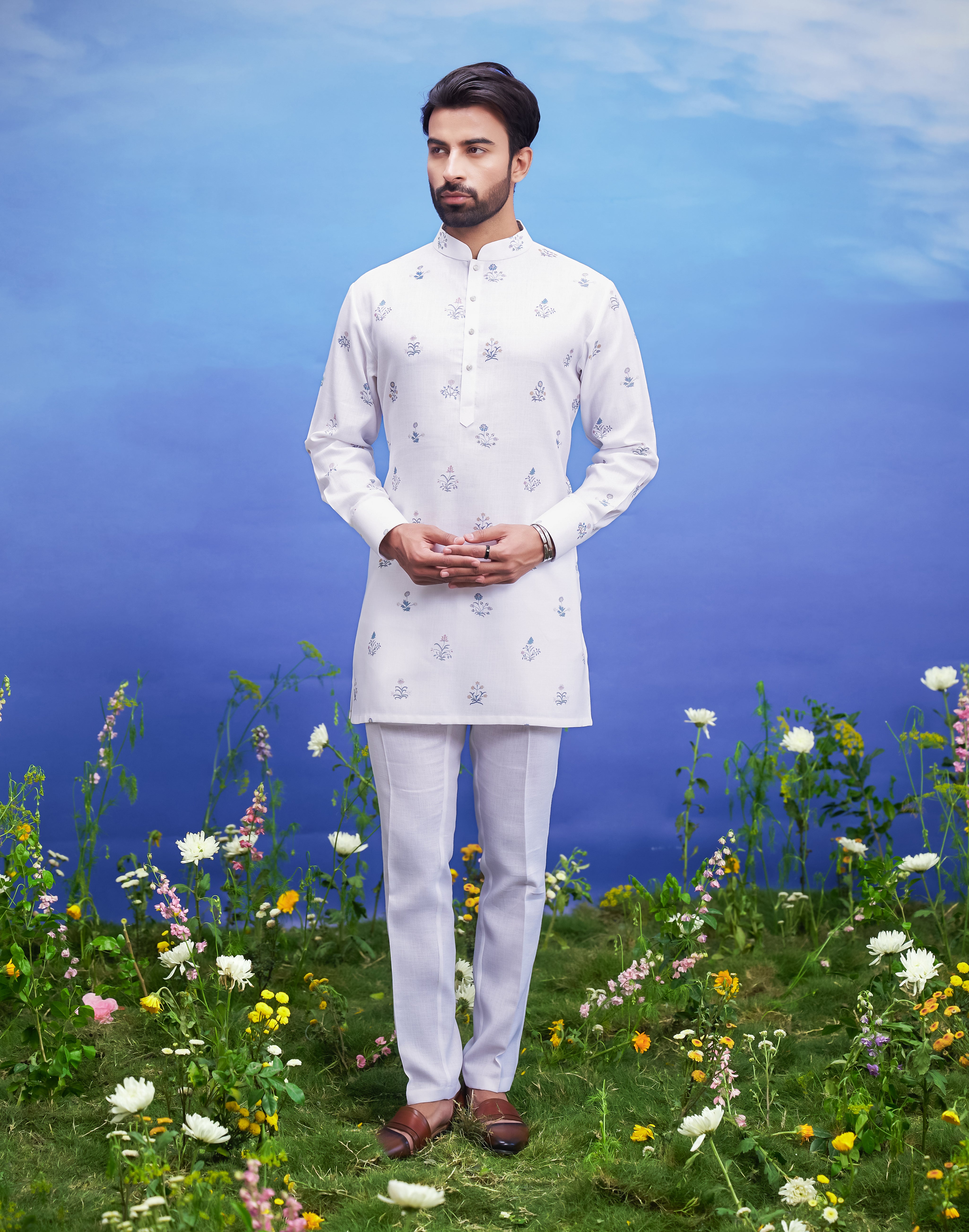 Men's white kurta set made of linen blend, displayed on a product page with size options.