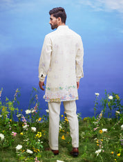Men's yellow kurta set featuring a linen blend kurta and bottom, with potential men's accessories like a jacket and pin.