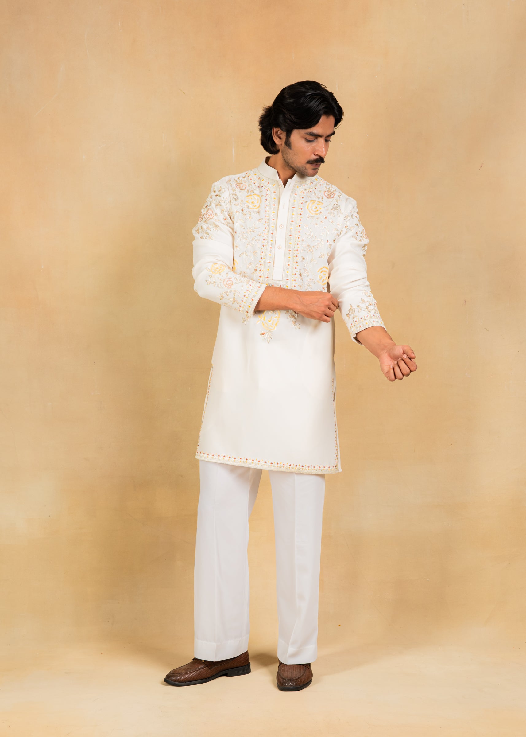 cream kurta set with pastel embroidery