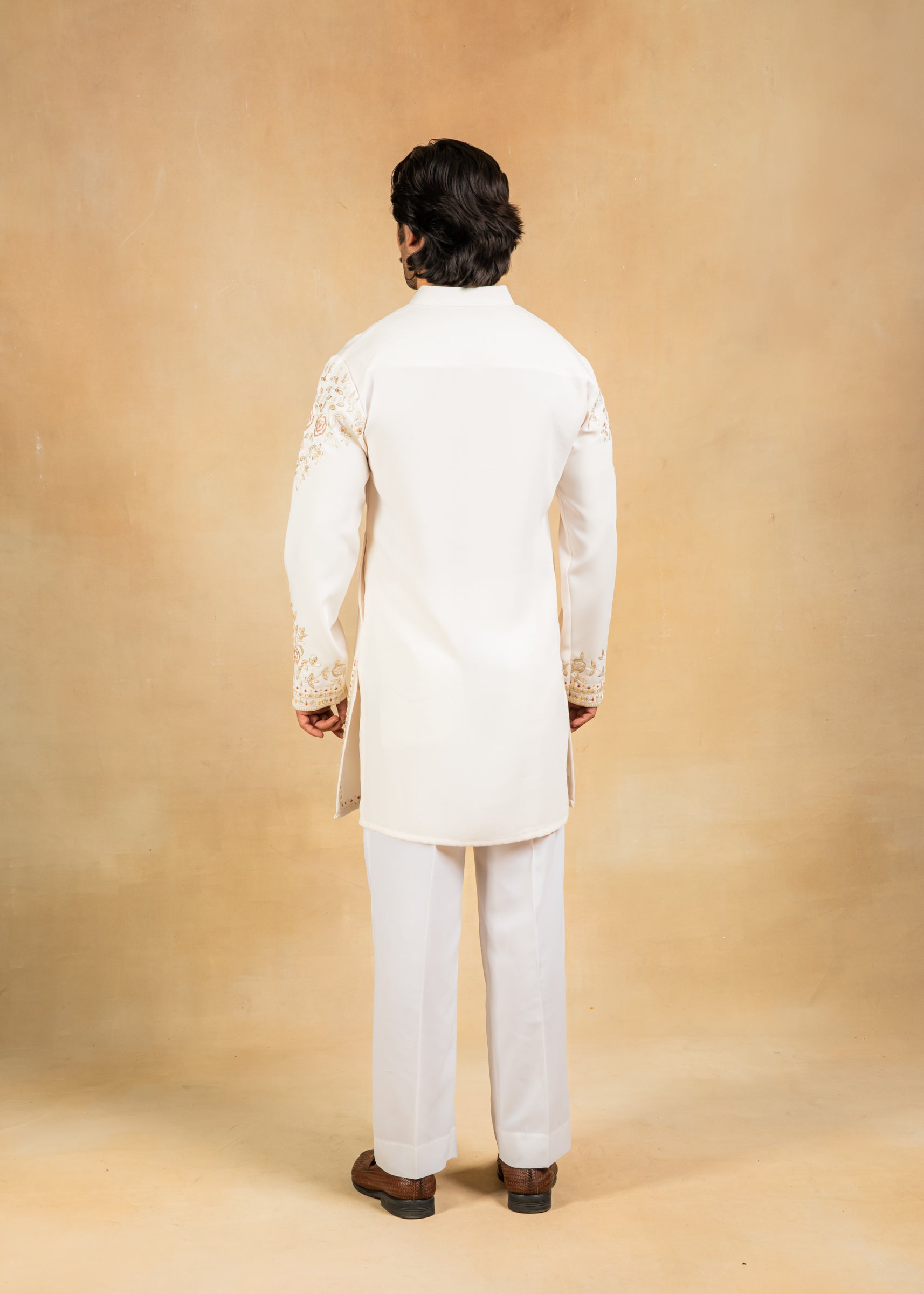 cream kurta set with pastel embroidery