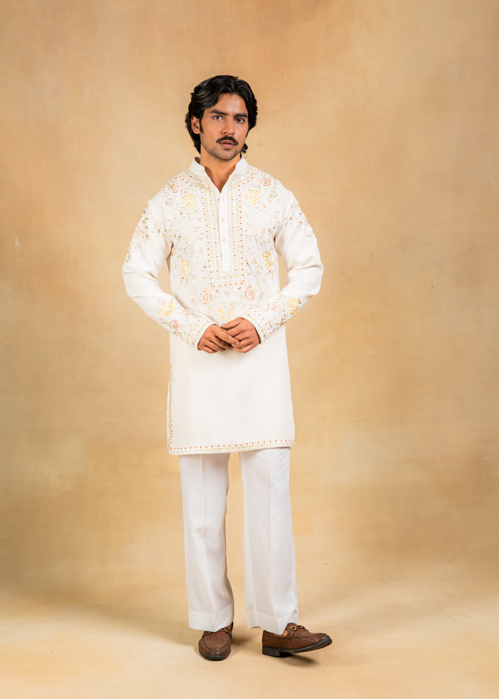 cream kurta set with pastel embroidery