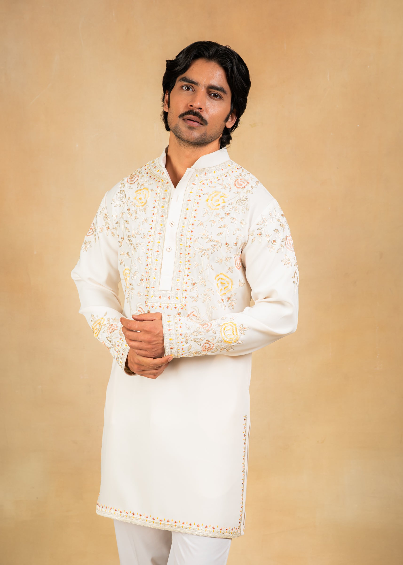 cream kurta set with pastel embroidery