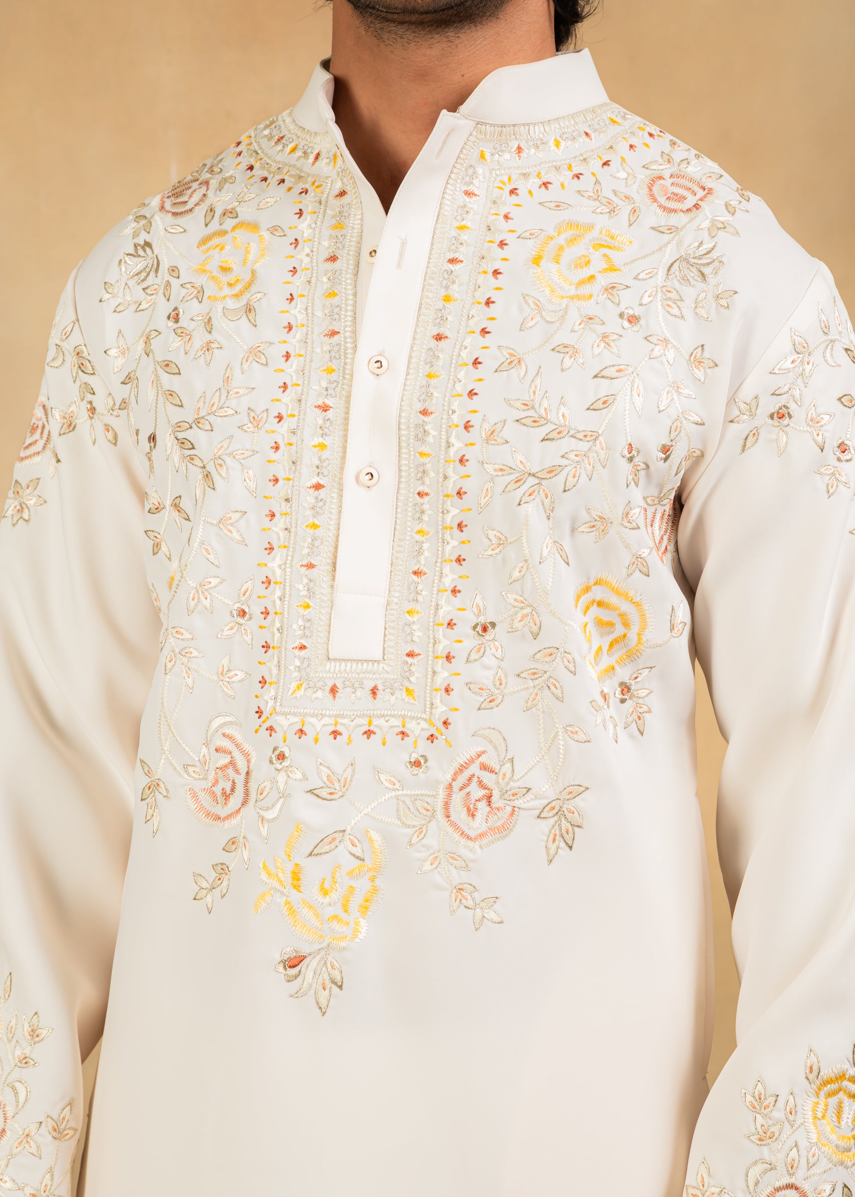 cream kurta set with pastel embroidery